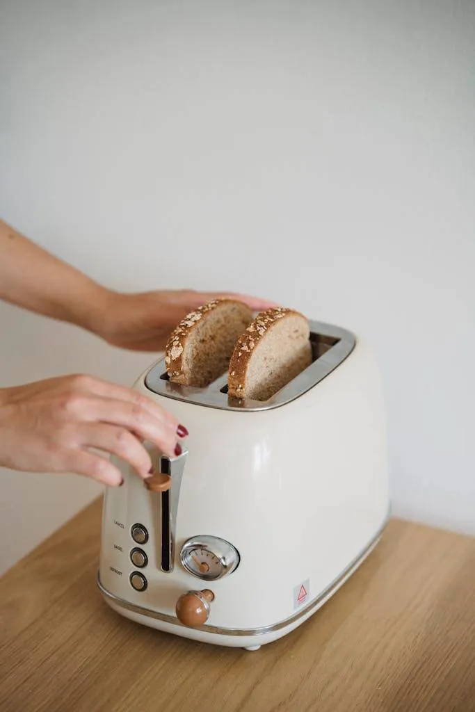 Close-up of Woman Putting Bread in a Toaster