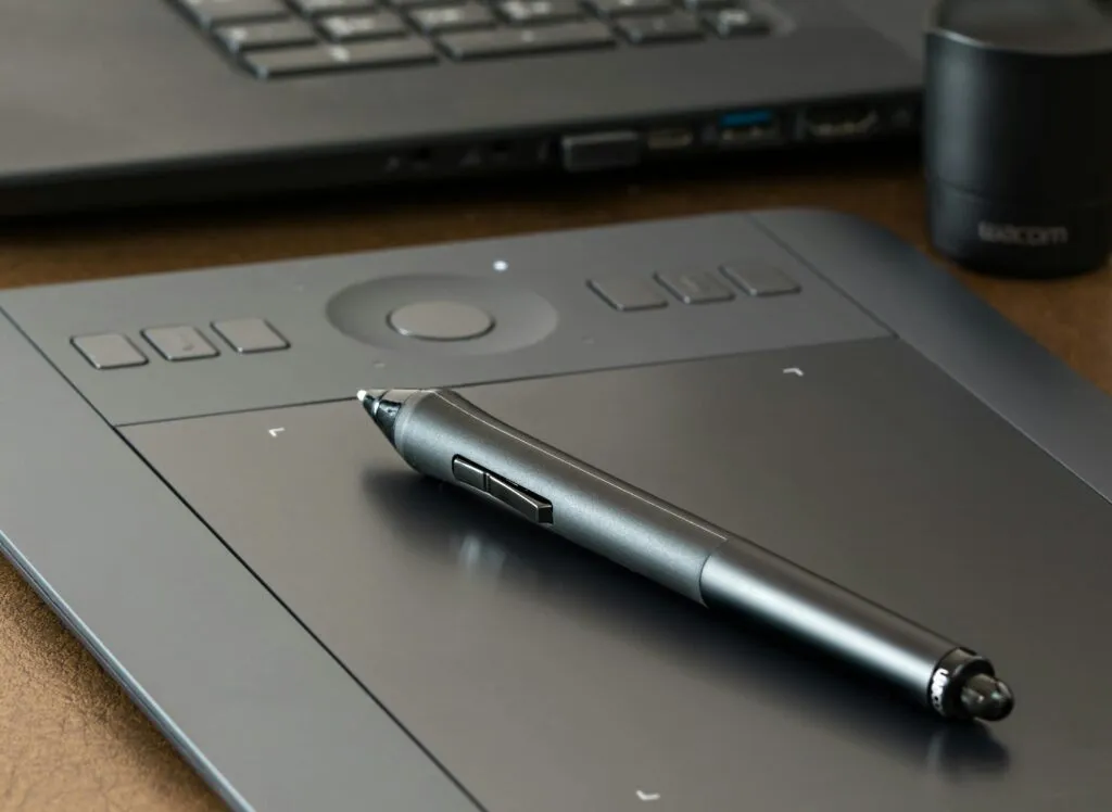 Close-up of a digital drawing tablet with a stylus pen, ideal for creative design work.