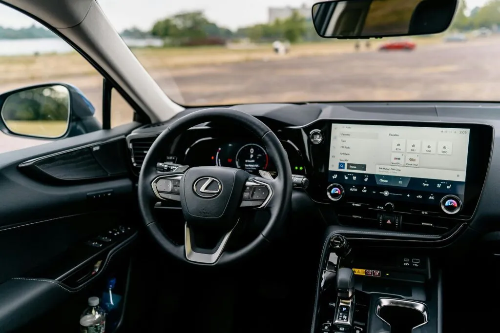 Detailed view of a Lexus car interior featuring a modern touchscreen and steering controls.