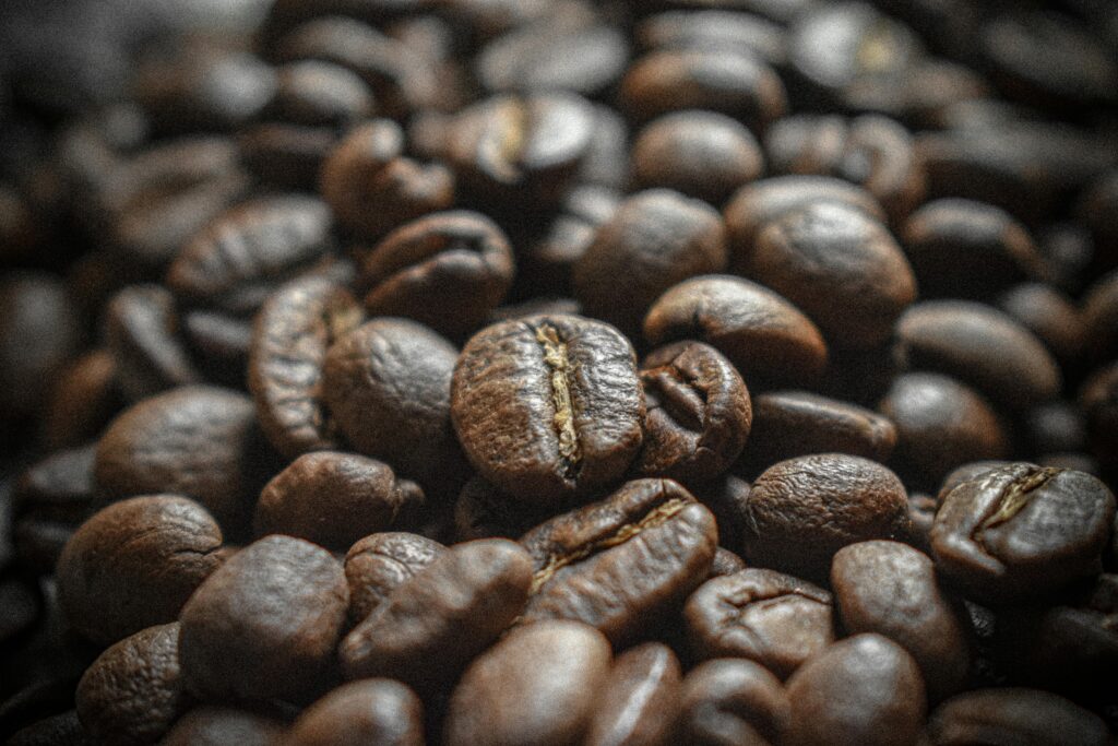 Artistic close-up of roasted coffee beans showcasing texture and rich brown hues.