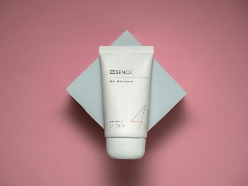Studio shot of luxury sun cream with SPF45 on a stylish pink background.