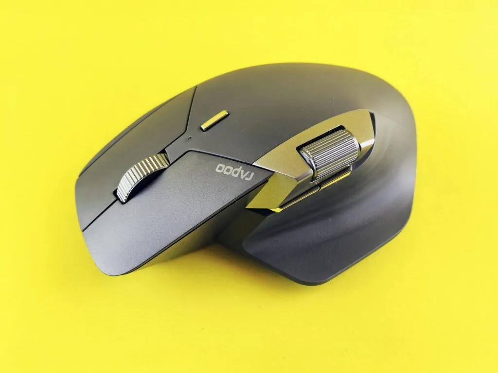 Close-up of a high-tech wireless mouse on a vibrant yellow backdrop, ideal for tech and lifestyle themes.